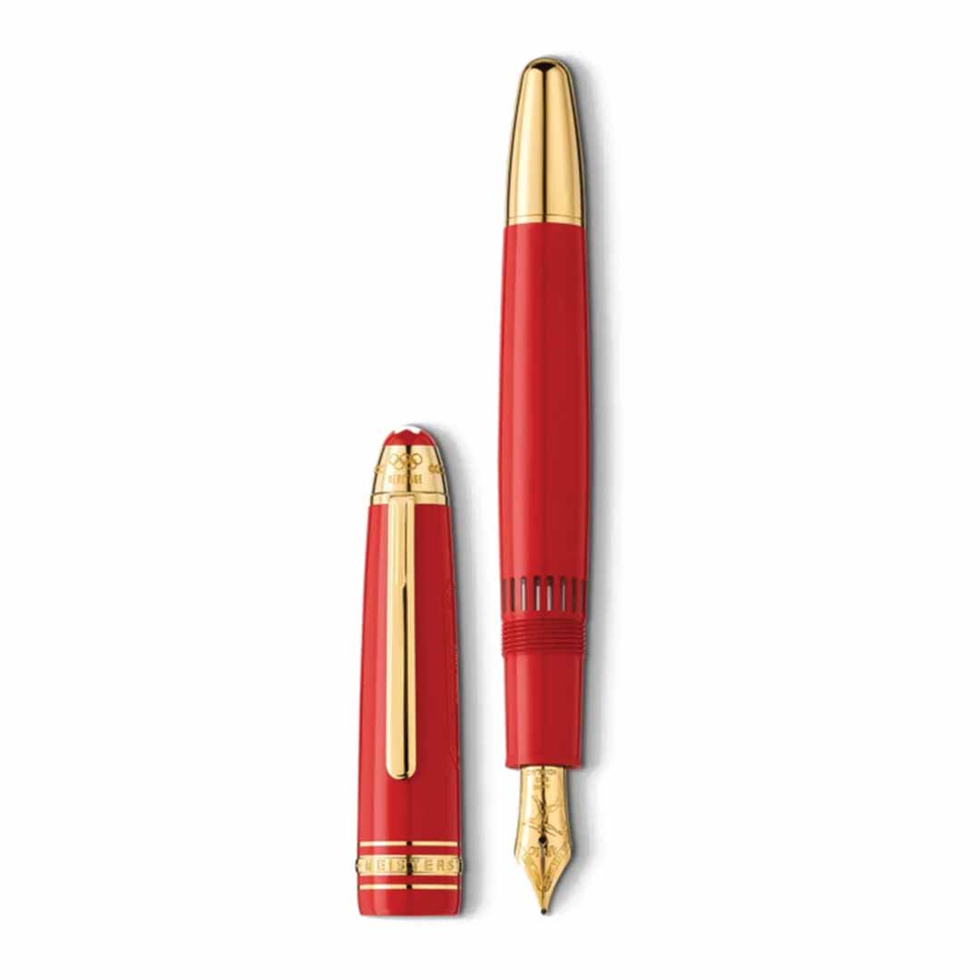 The Montblanc Meisterstück x Olympic Heritage Paris 1924 Le Grand fountain pen is displayed, showcasing its red color with gold accents. The pen stands upright with the cap positioned horizontally beside it, highlighting a gold nib and paying homage to the timeless elegance of the Paris 1924 Olympic Games.