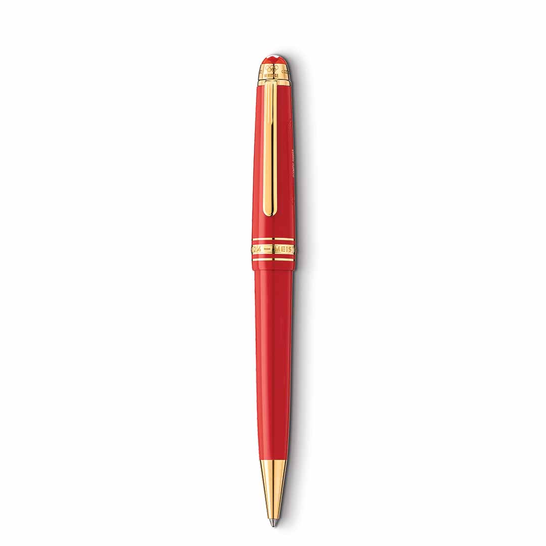 The Montblanc Meisterstuck X Olympic Heritage Paris 1924 Midsize Ballpoint Pen is a luxurious red ballpoint pen adorned with gold accents. Its sleek and glossy design is inspired by the Paris Olympic Games of 1924. The pen features a cap, clip, and intricate detailing near the top.