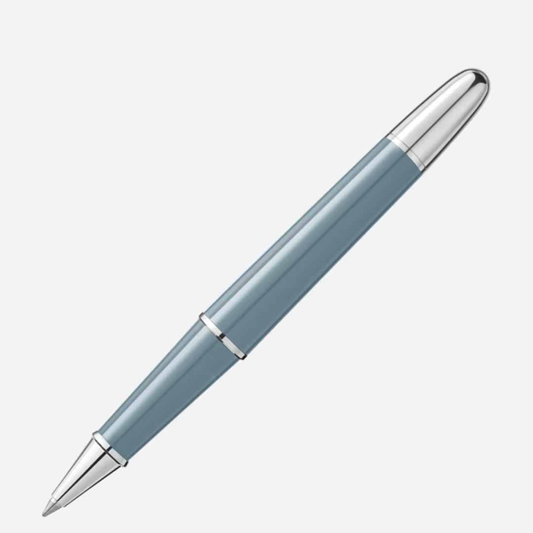 The Montblanc Meisterstuck X Olympic Heritage Chamonix 1924 Classique Rollerball Pen, featuring a sleek blue design with silver accents and a pointed tip, is positioned diagonally against a light gray background.