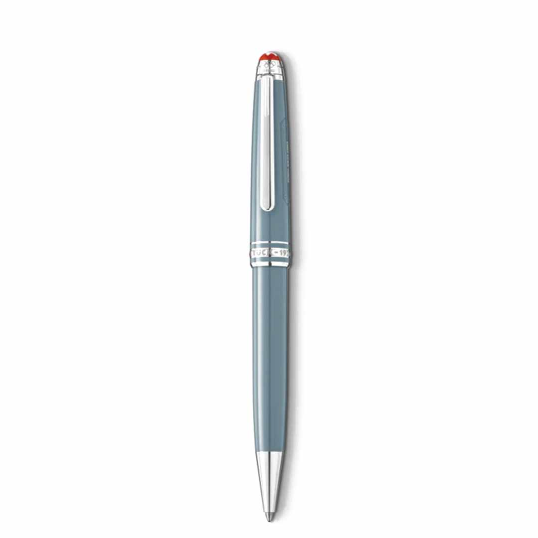 The Montblanc Meisterstück X Olympic Heritage Chamonix 1924 Classique Ballpoint Pen, a sleek silver and gray writing instrument featuring a shiny clip and a red accent on the cap, reminiscent of the Meisterstück centenary design, is showcased standing vertically against a plain white background.