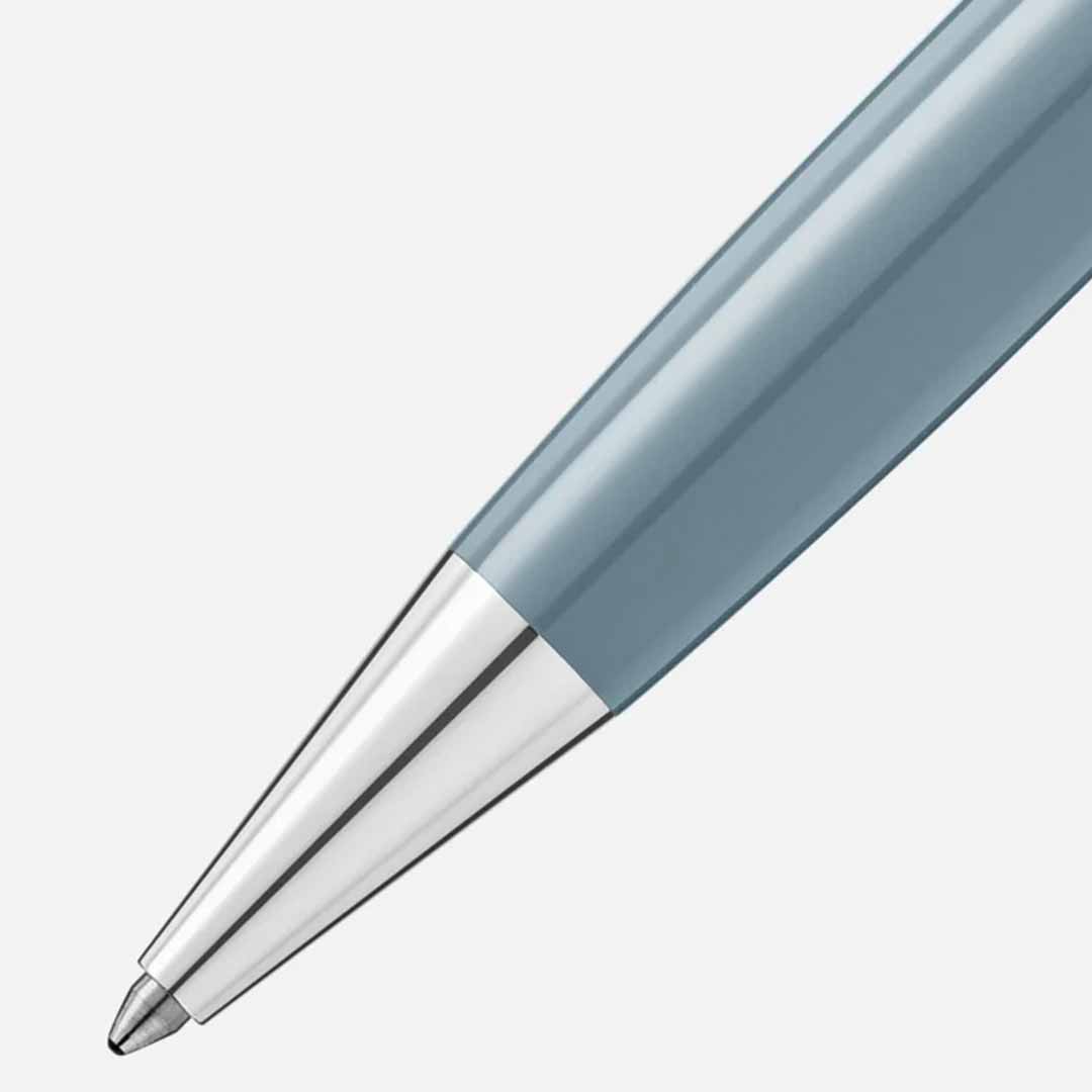 Close-up of a Montblanc Meisterstück X Olympic Heritage Chamonix 1924 Classique Ballpoint Pen with a silver tip against a light gray background. The pen's sleek design highlights its metallic finish and smooth body.