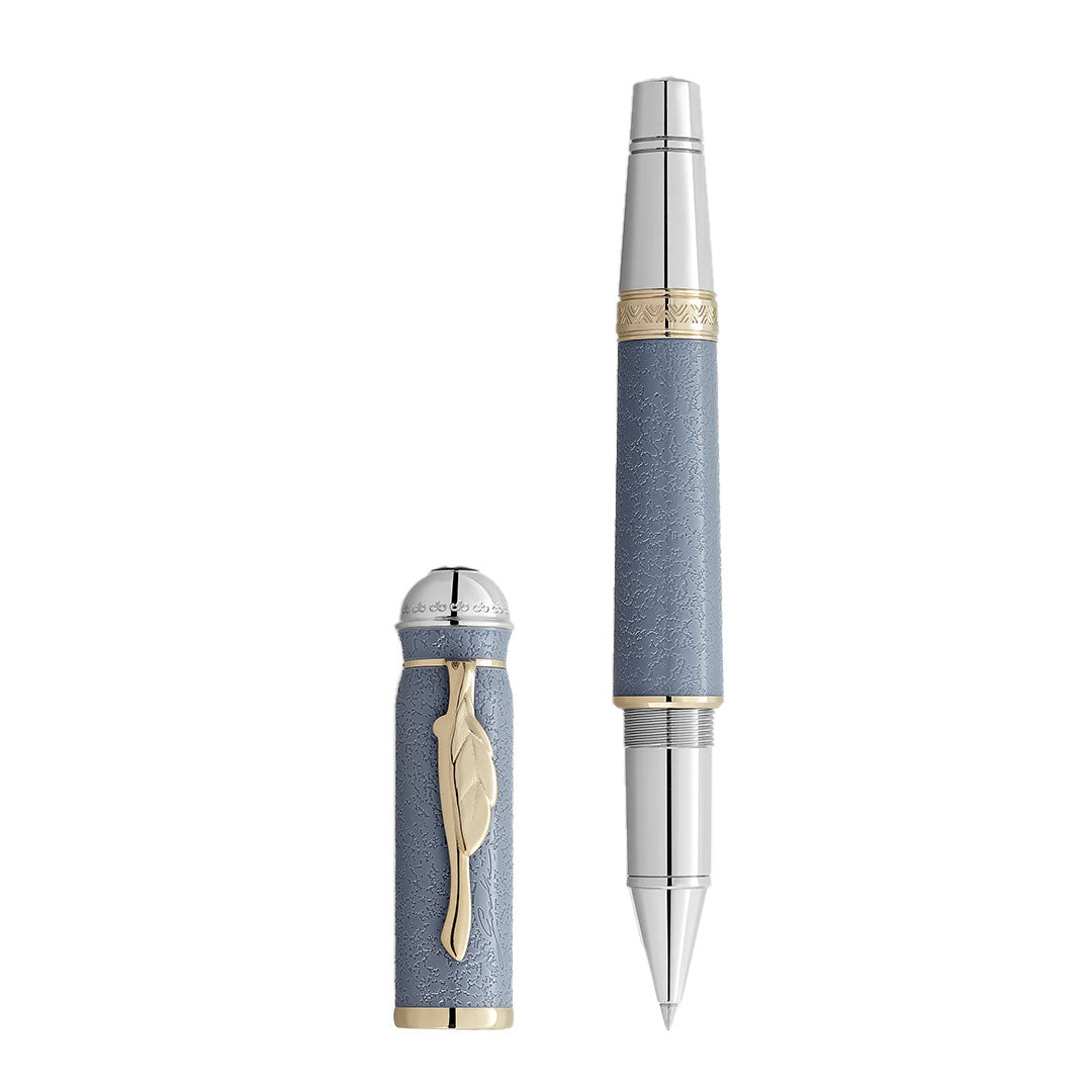The Montblanc Writers Edition Homage to Johann Wolfgang von Goethe Limited Edition Rollerball Pen features a textured light blue barrel, gold accents, and a cap with a gold feather-shaped clip and silver detailing inspired by German literature.