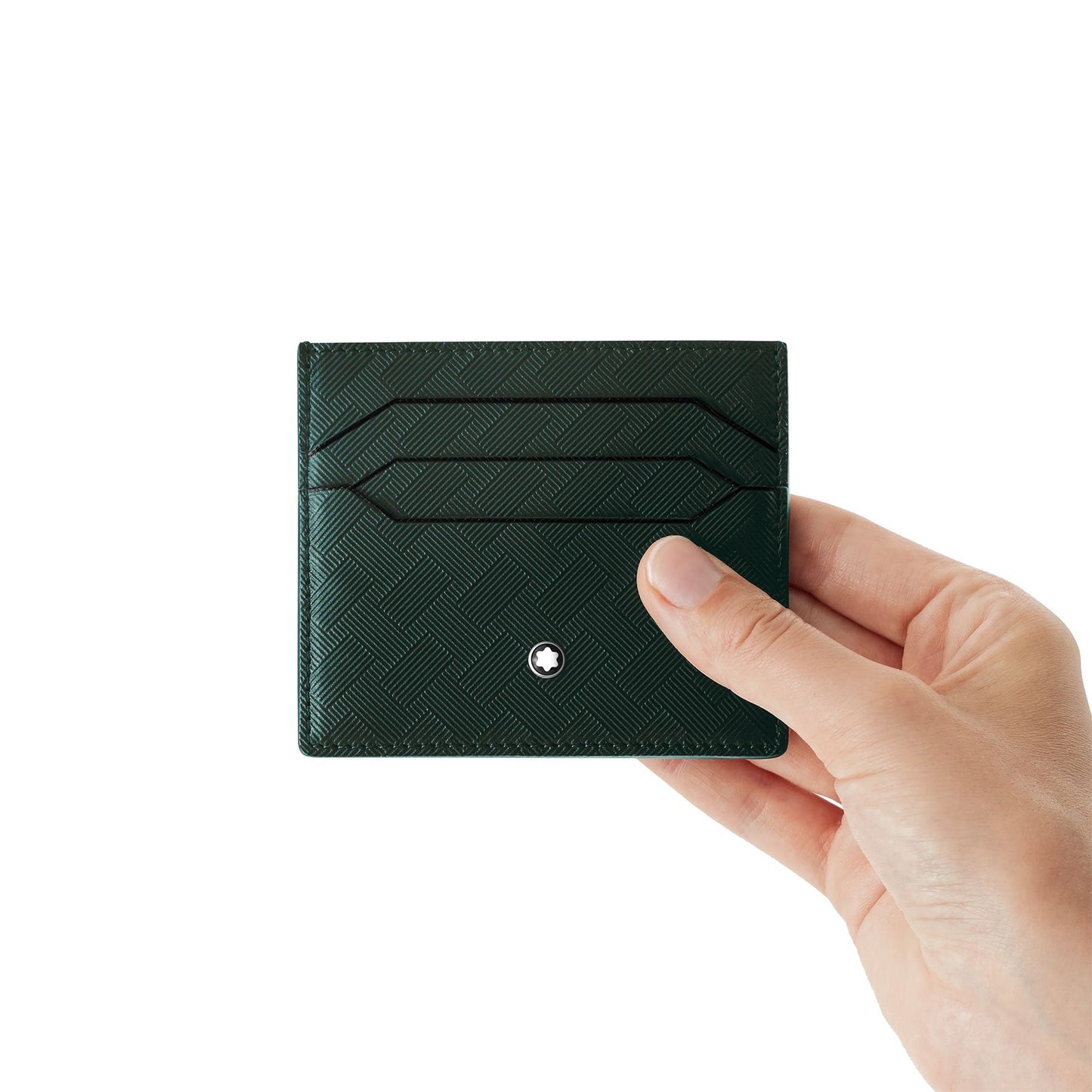 A hand holds a Montblanc Extreme3.0 Leather Card Holder against a plain white background. This dark green, full-grain bovine leather card holder from Montblanc features two card slots and a small silver emblem on the front, combining elegance with practicality.