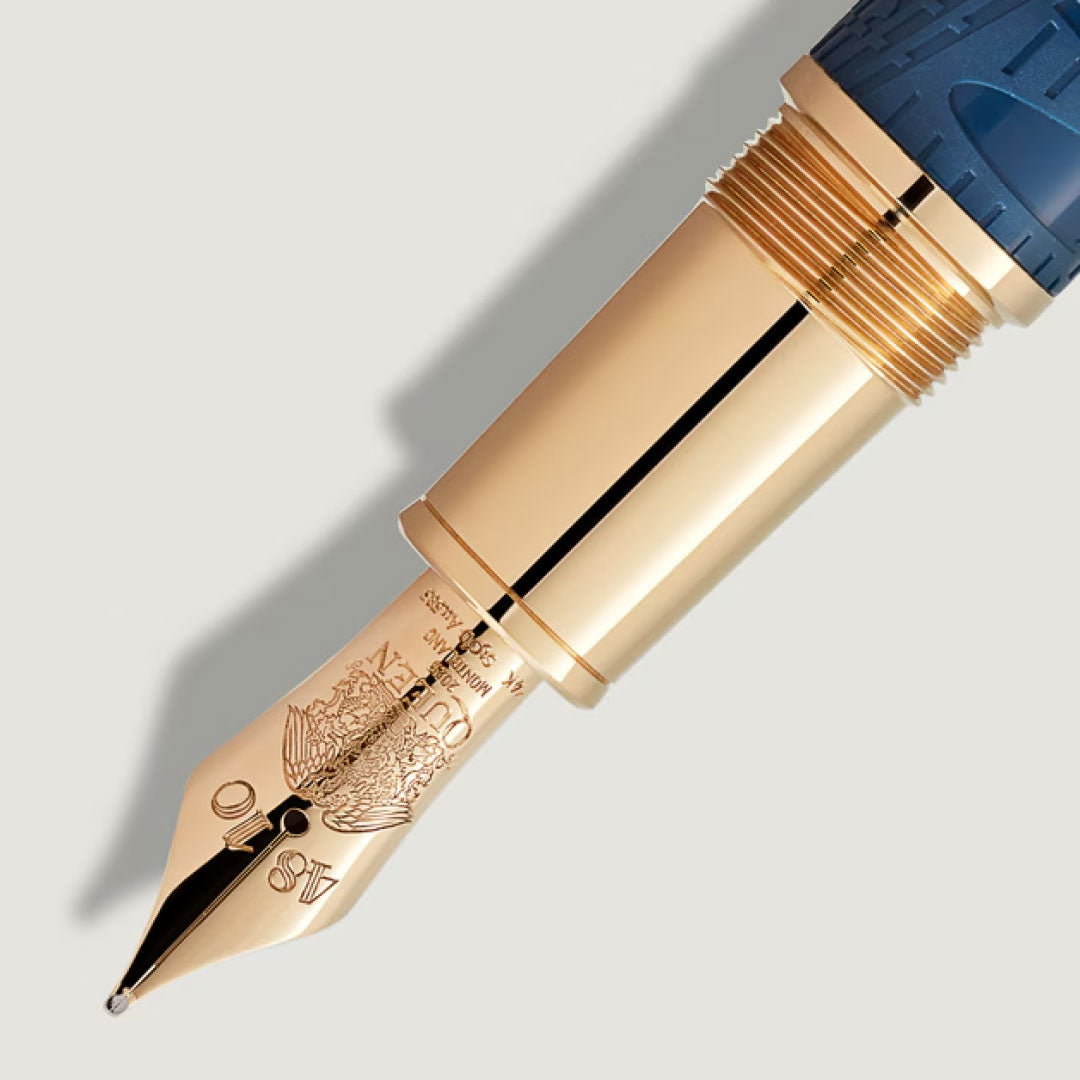 Close-up of the gold nib with engraved details on the Montblanc Great Characters Homage to Queen Special Edition Fountain Pen, featuring a blue and gold barrel, set against a light background.