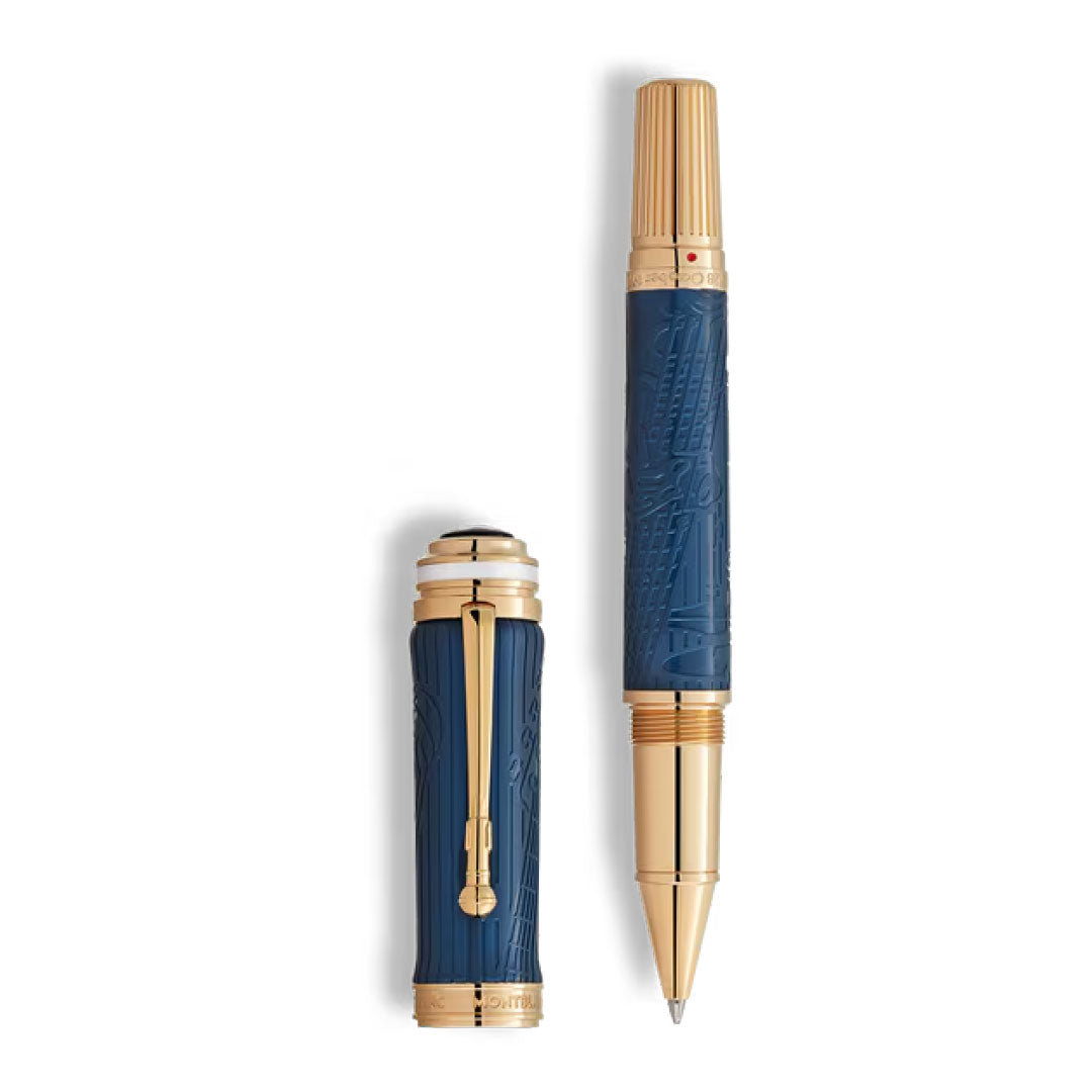 A Montblanc Great Characters Homage to Queen Special Edition Rollerball Pen in blue and gold with intricate engravings, displayed uncapped with the cap upright beside it on a white background.