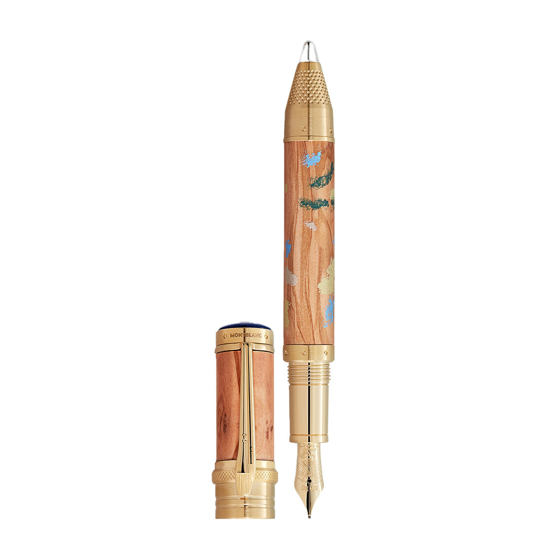 The Montblanc Masters of Art Homage to Pierre-Auguste Renoir Limited Edition 4810 Fountain Pen features a gold nib and cap, with a patterned wooden barrel reflecting Impressionist art. The cap is shown beside the pen to highlight its elegant design.