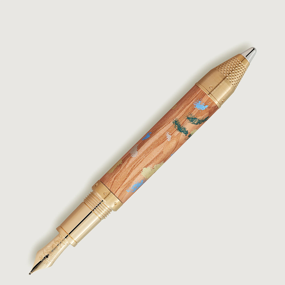 The Montblanc Masters of Art Homage to Pierre-Auguste Renoir Limited Edition 4810 Fountain Pen features a gold nib and cap, a wooden barrel with colorful Impressionist nature designs, and a textured gold clicker.