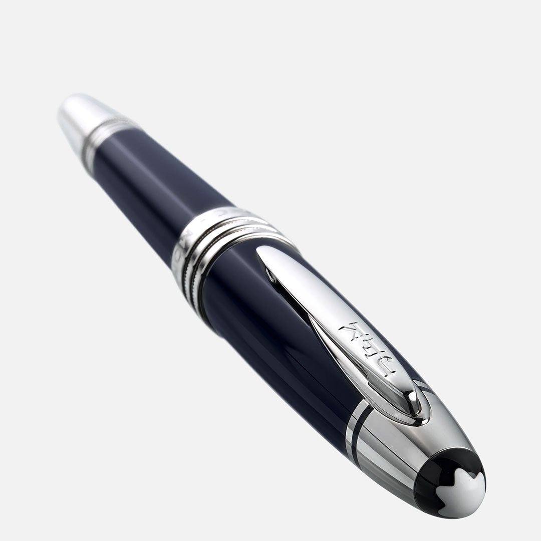A close-up of the Montblanc John F. Kennedy Special Edition Rollerball Pen, featuring silver accents and a clip, shown diagonally on a plain light background.