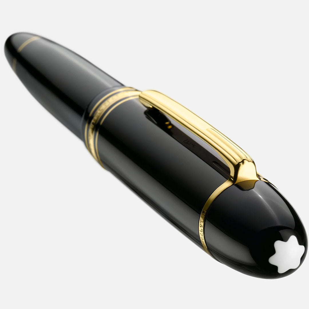 A close-up of the Montblanc Meisterstuck Yellow Gold Coated 149 Fountain Pen with gold accents and the signature white star emblem on the cap, displayed against a light background.