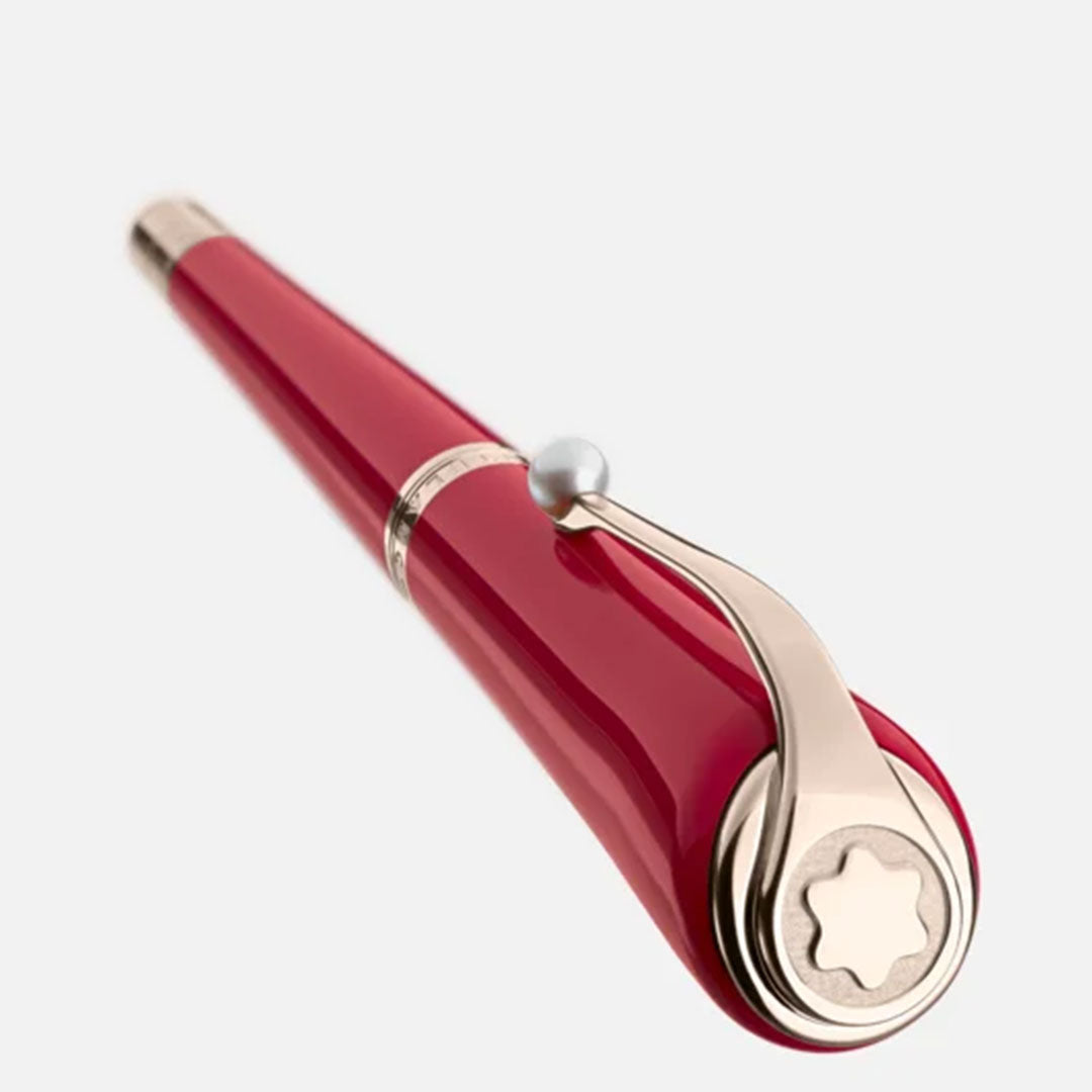 Close-up of the Montblanc Muses Marilyn Monroe Special Edition Rollerball Pen, featuring a sleek, red design reminiscent of Ruby Tuesday lipstick, with elegant gold clip and accents. It boasts a curved shape and silver tip, set against a plain, light background.