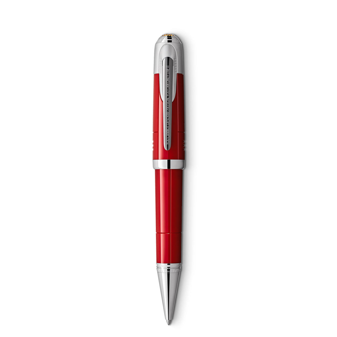 The Montblanc Great Characters Enzo Ferrari Special Edition Ballpoint Pen, featuring a striking red and silver design with a shiny metallic clip and pointed tip, stands vertically against a white background.