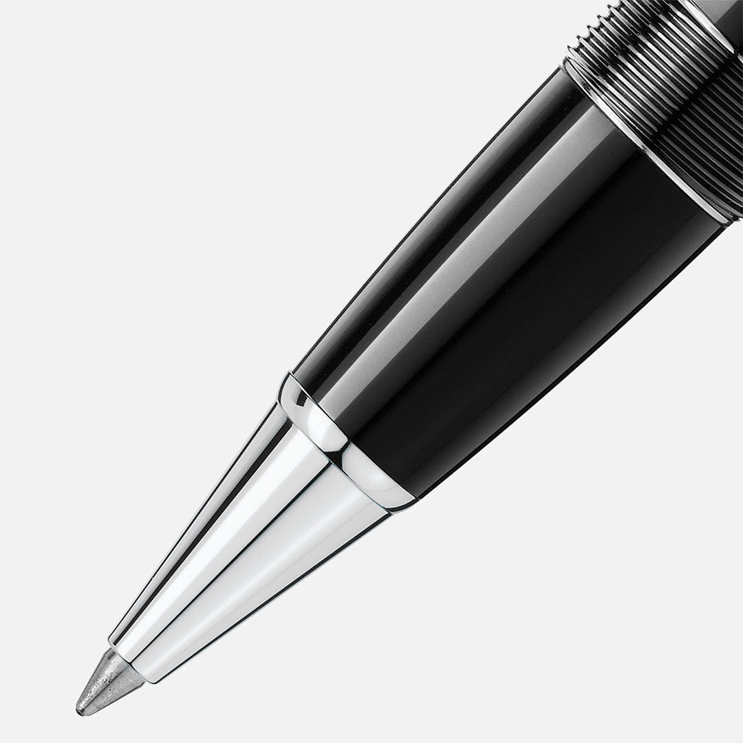 Close-up of the tip of a Montblanc Meisterstück Platinum Coated Legrand Rollerball Pen, made from black precious resin with platinum-coated accents, on a plain white background.