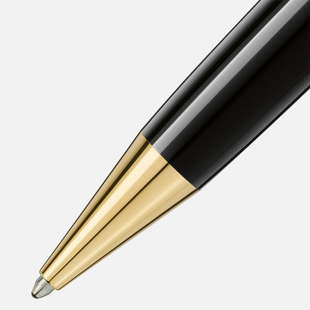 Close-up of the Montblanc Meisterstuck Yellow Gold Coated Le Grand Ballpoint Pen, showcasing its shiny gold-toned section and glossy black resin body against a plain light background.