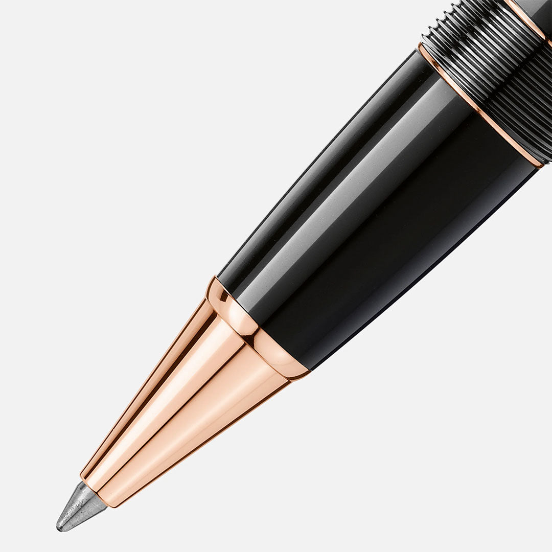 A close-up of the Montblanc Meisterstuck Rose Gold Coated Legrand Rollerball Pen tip highlights its glossy black barrel and rose gold accents, displayed against a plain white background.