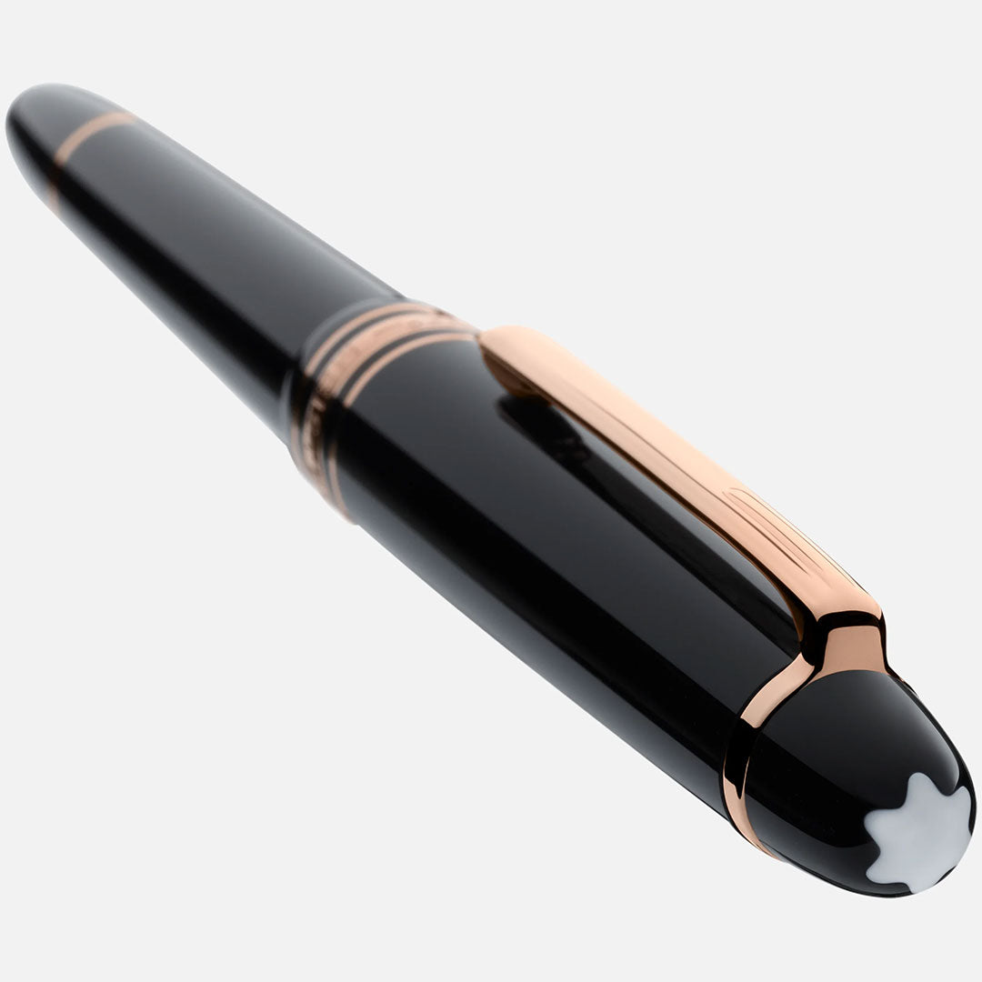 A Montblanc Meisterstuck Rose Gold Coated Rollerball Pen with rose-gold accents and the iconic white star emblem on the cap, displayed on a white background.