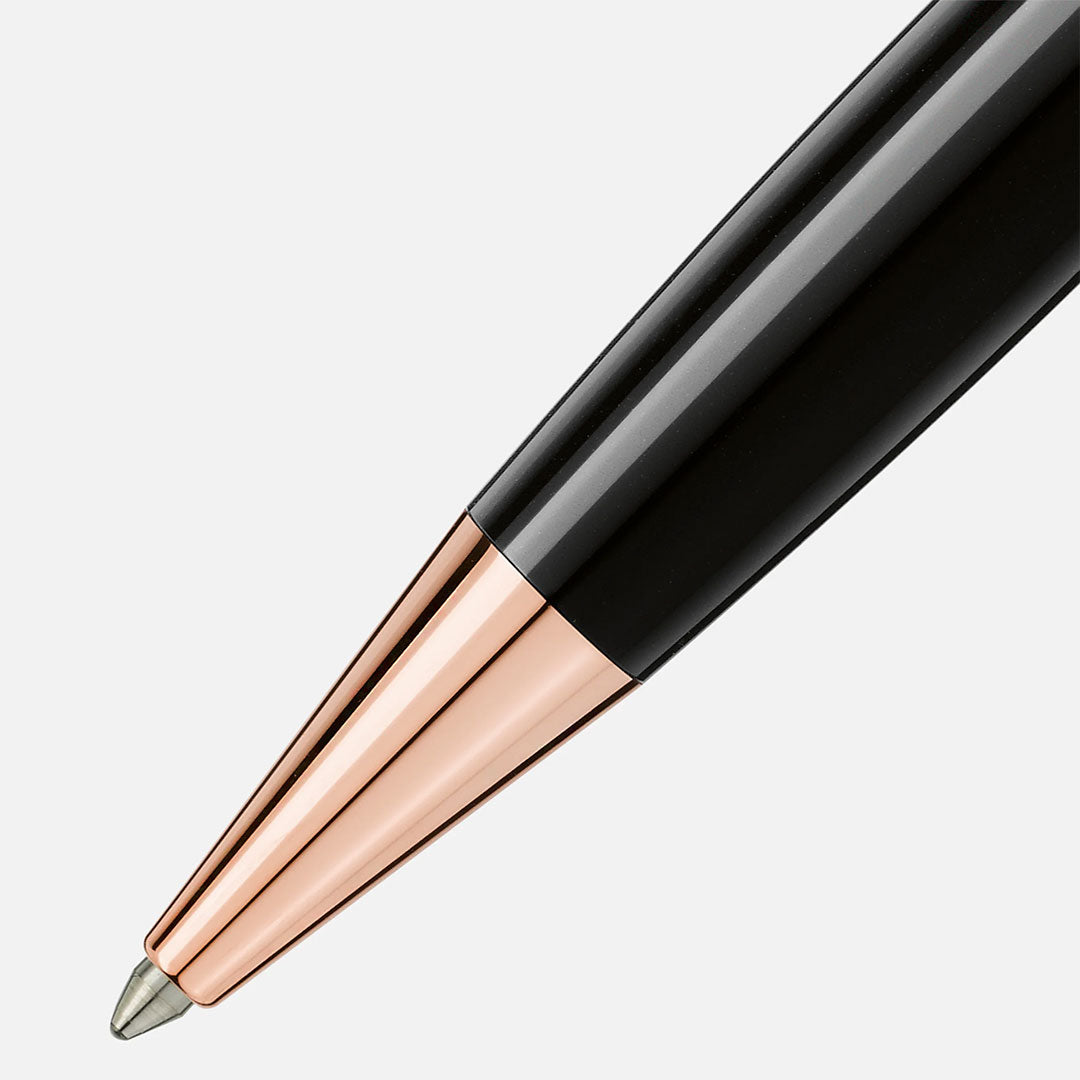 Close-up of the Montblanc Meisterstuck Ballpoint Pen featuring a shiny rose gold-coated metal tip, displaying luxury and elegance against a plain white background.