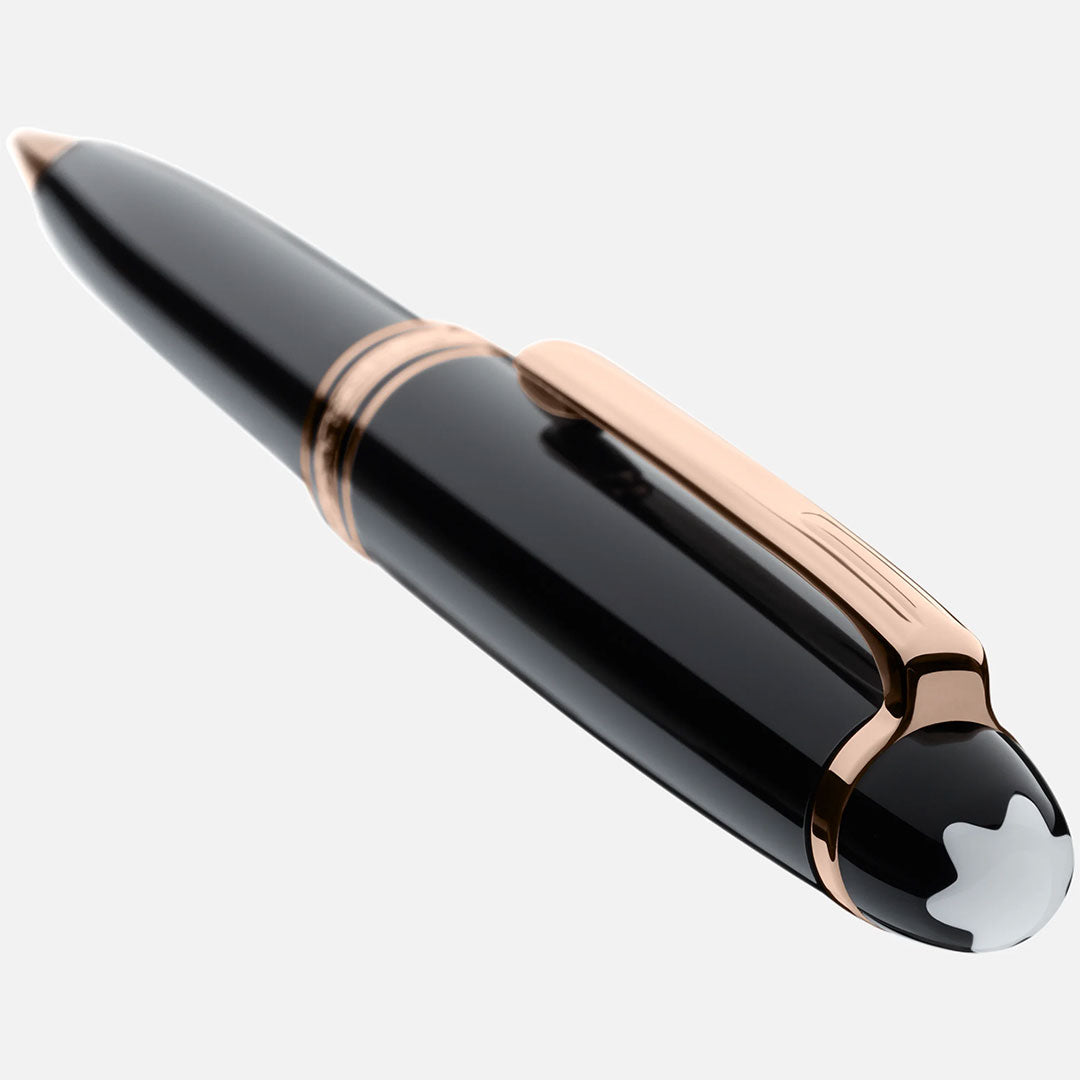 A glossy black Montblanc Meisterstück Rose Gold Coated Ballpoint Pen with rose gold accents and the signature white star emblem on the cap, angled against a plain light background—an icon of luxury by Montblanc.
