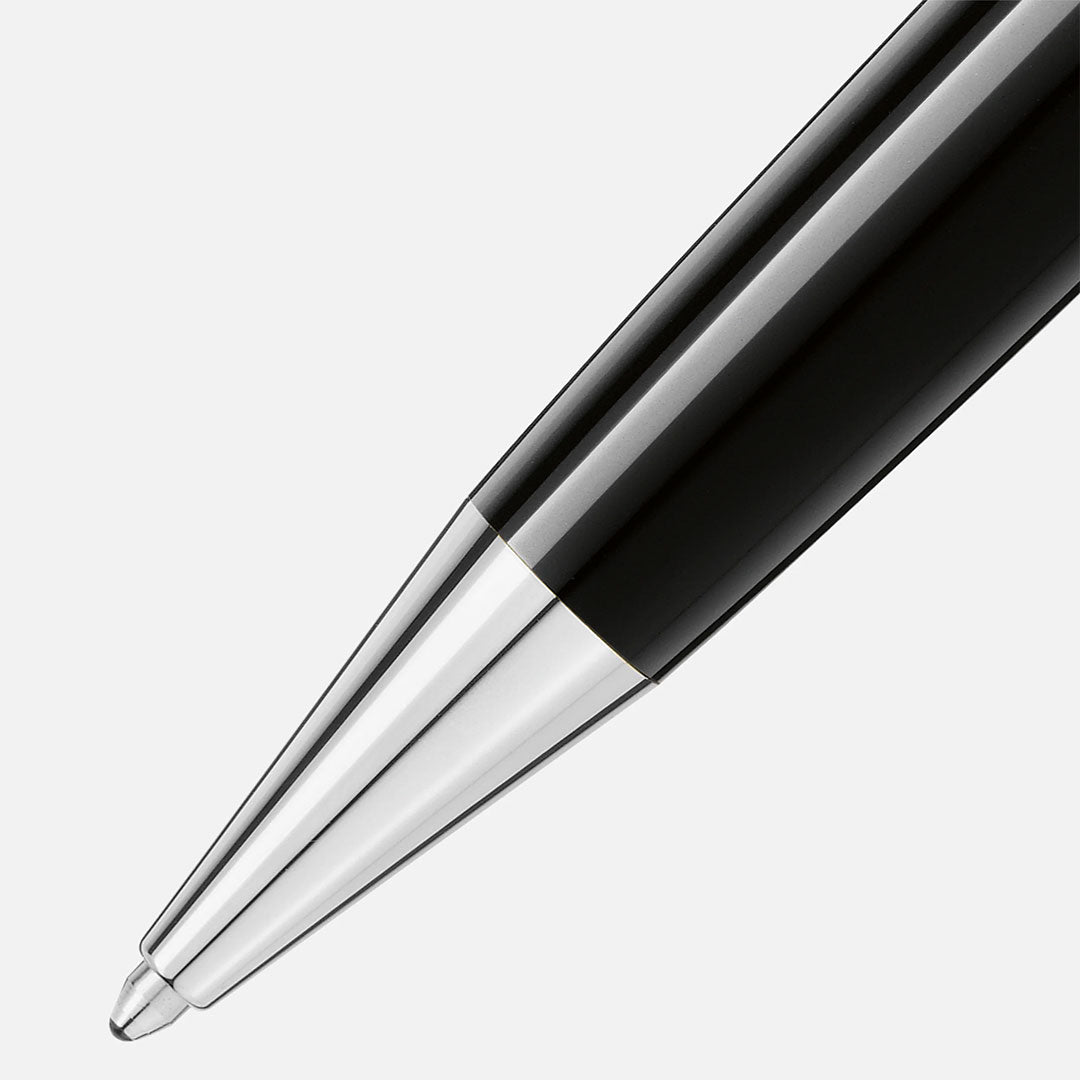 Close-up of the tip of the Montblanc Meisterstuck Platinum Coated Midsize Ballpoint Pen, crafted from black precious resin with platinum-coated accents, set against a plain white background.