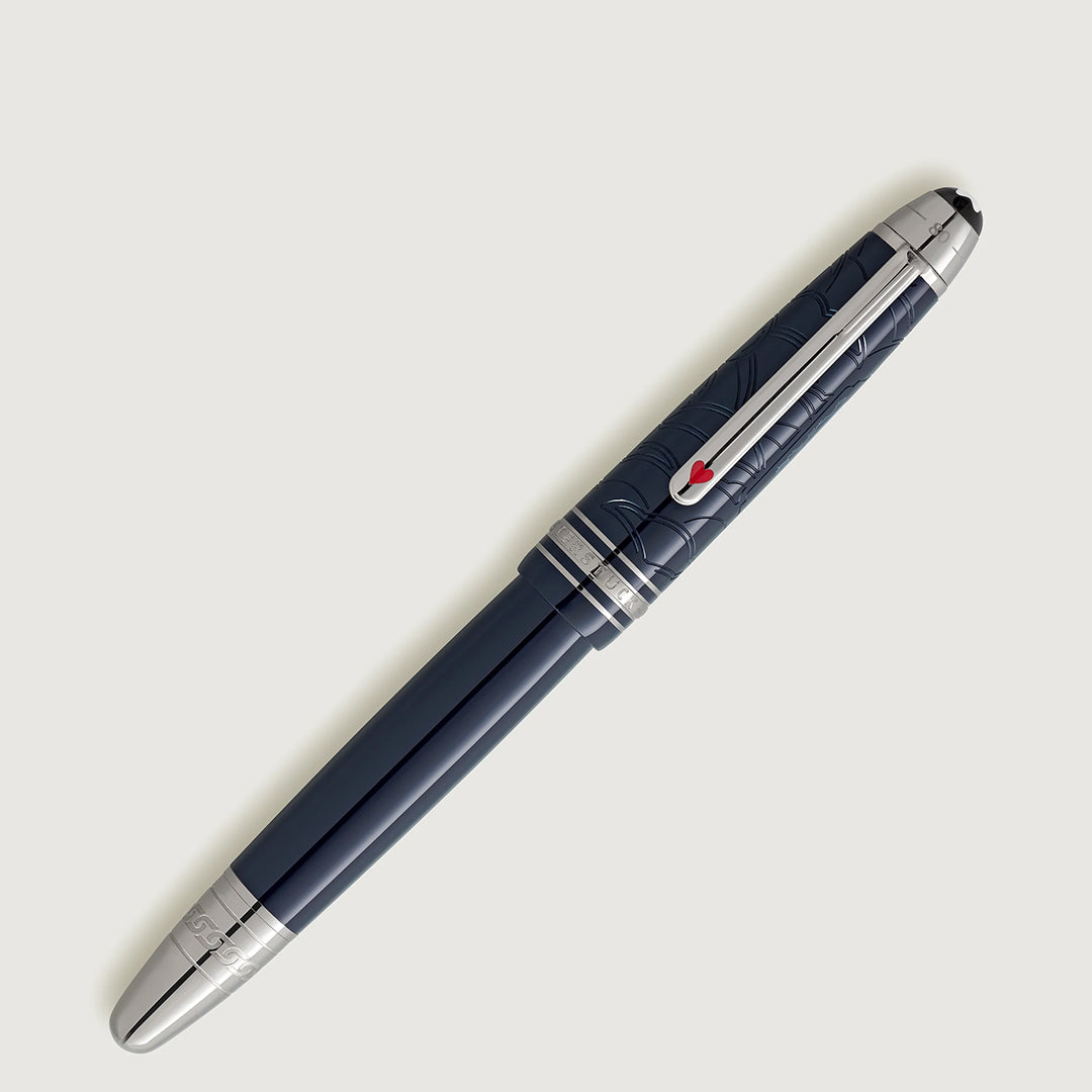 A sleek, Montblanc Meisterstuck Around the World in 80 Days Legrand Fountain Pen with silver accents and a red emblem on the clip is set against a light gray background, featuring intricate engravings on the upper section that echo Jules Verne's adventurous elegance.