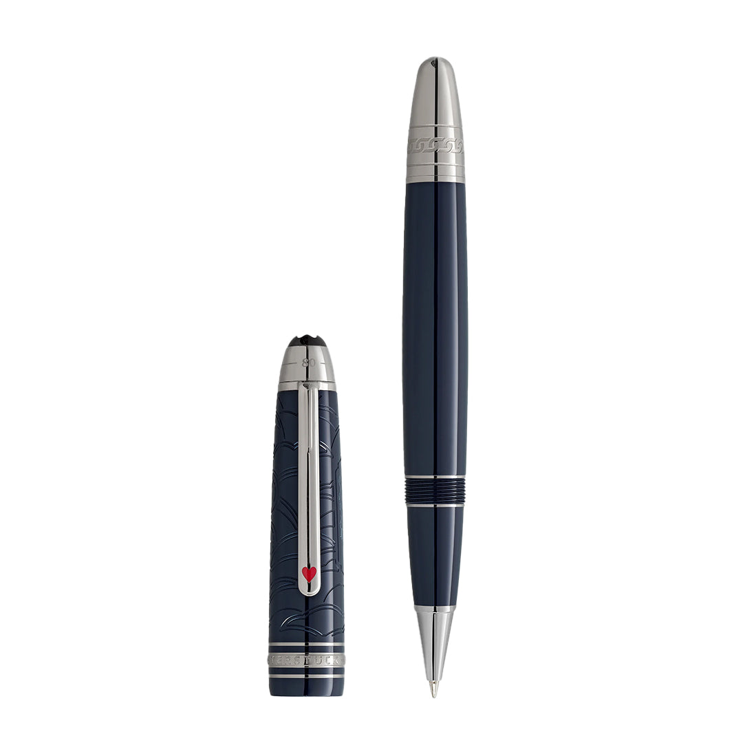 The Montblanc Meisterstück Around the World in 80 Days Legrand Rollerball Pen, elegantly crafted in dark blue precious resin with silver accents and a red emblem clip, stands vertically on a white background, echoing the adventurous spirit of its namesake.