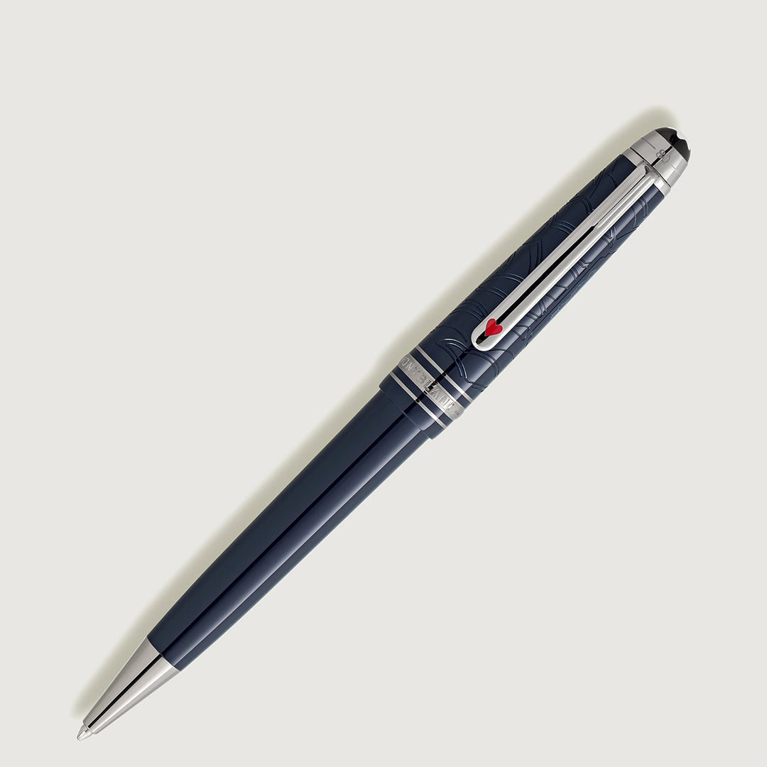 A Montblanc Meisterstück Around the World in 80 Days Midsize Ballpoint Pen, featuring a sleek dark gray finish with a silver clip and intricate cap engravings, evokes a mysterious allure against a light gray background.