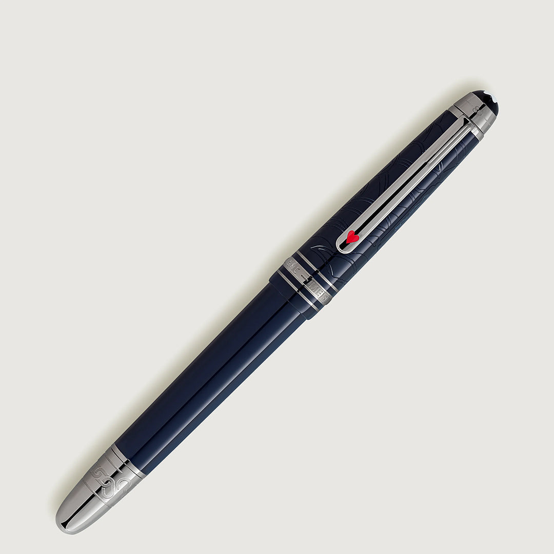 A sleek Montblanc Meisterstück Around the World in 80 Days Classique fountain pen, dark blue with silver accents and a red clip detail, set against a light backdrop, reminiscent of Jules Verne's imagination.