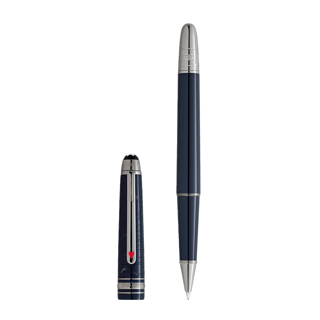 A sleek Montblanc Meisterstück Around the World in 80 Days Classique Rollerball pen, dark blue with silver accents, rests beside its cap. The pointed tip gleams, and the cap features a silver clip with red details and engraved patterns inspiring timeless journeys.