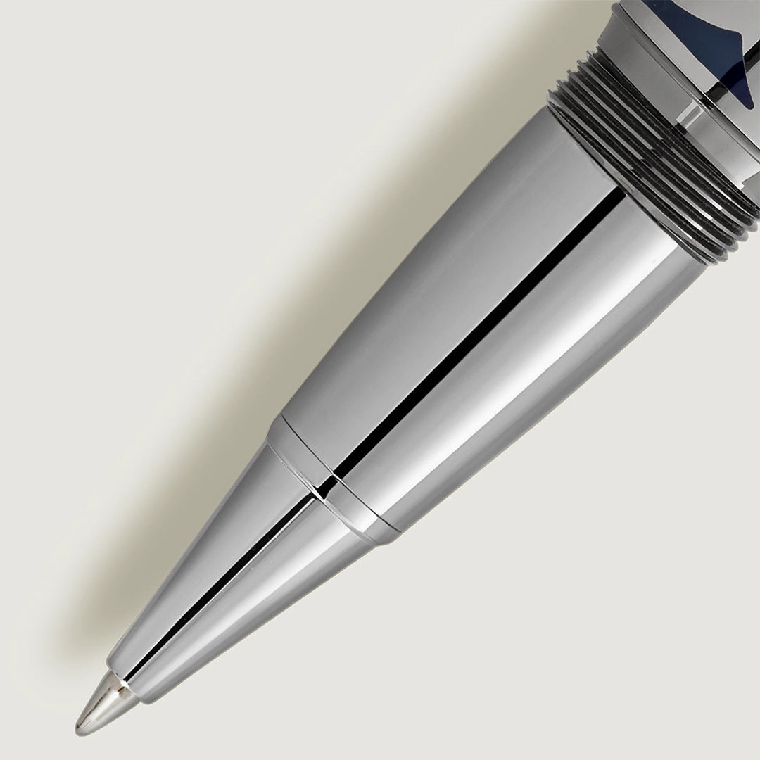 Close-up of the Montblanc Meisterstuck Around the World in 80 Days Solitaire Legrand Rollerball Pen tip on light gray background, highlighting its smooth metallic surface, reflective finish, and fine point for detailed writing.