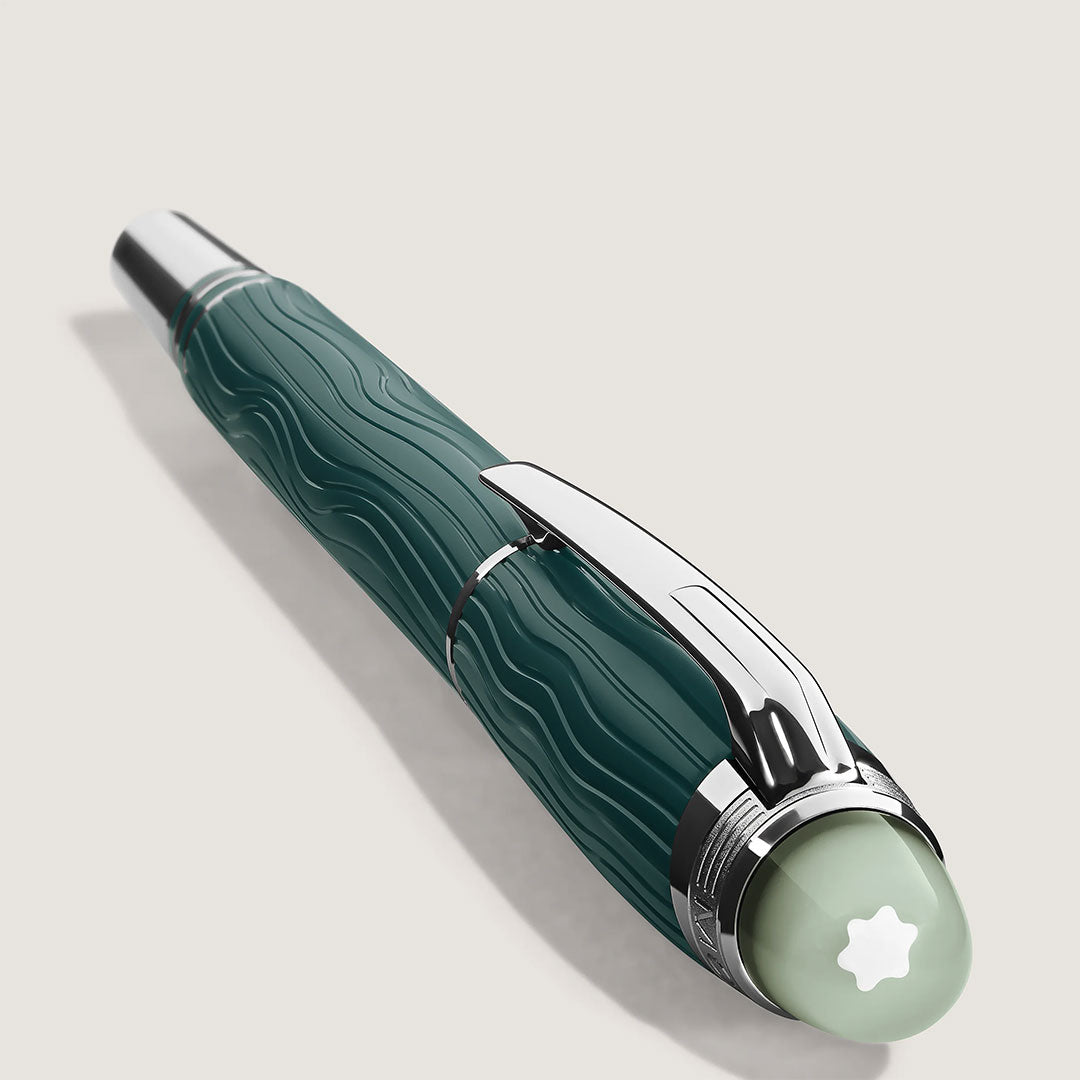 The Montblanc Starwalker Polar Green Precious Resin Fineliner Pen features a textured dark green barrel, platinum accents, and a pale green cap-top with a white star emblem, shown on a light background.