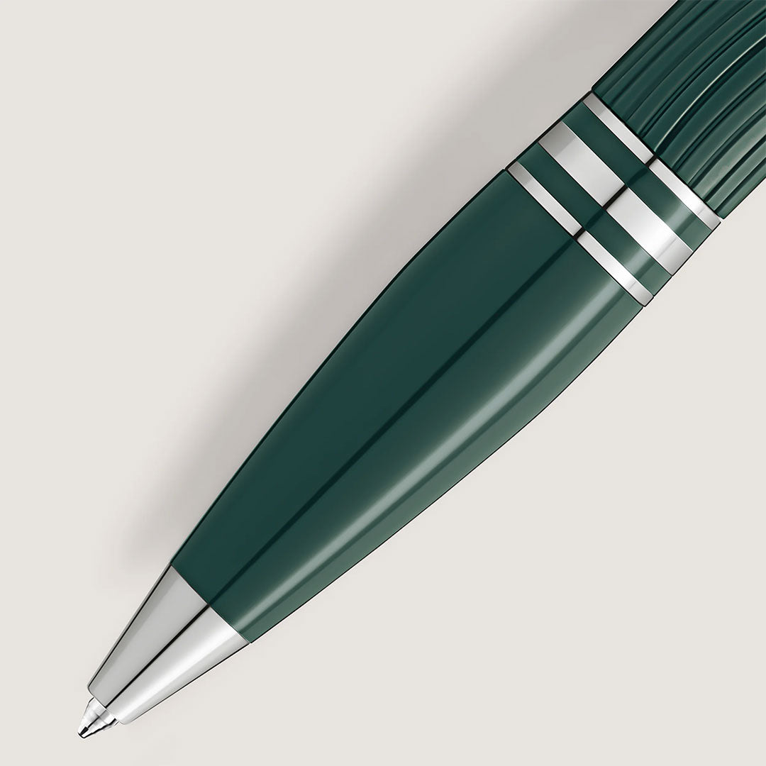 A close-up of the Montblanc Starwalker Polar Green Precious Resin Ballpoint Pen shows platinum-coated details and silver accents, with the tip and barrel visible against a light background.