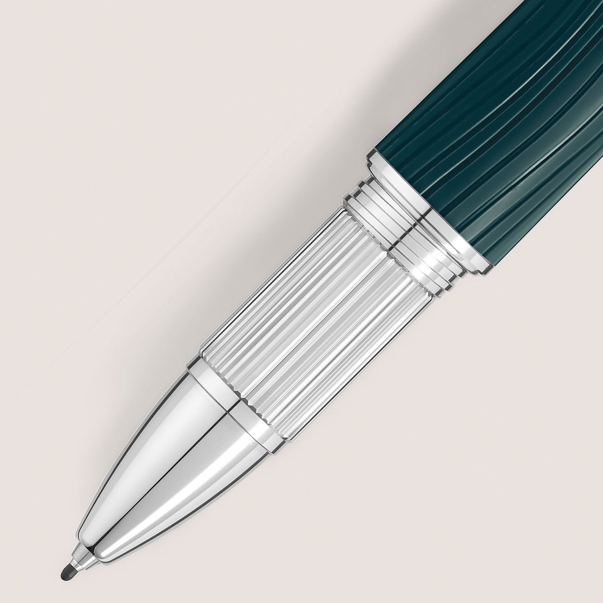 Close-up of the Montblanc StarWalker PolarGreen Doue Fineliner Pen with a ribbed grip, silver and teal accents, set against a light beige background. The tip is extended, echoing Northern Lights-inspired colors.