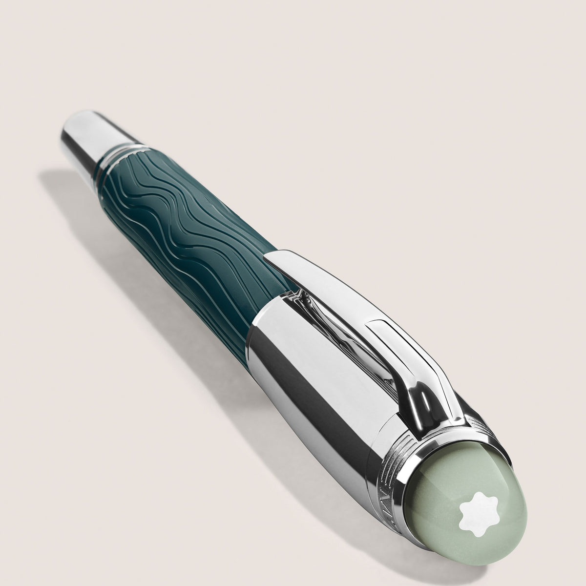 The Montblanc StarWalker PolarGreen Doue Fineliner Pen features a silver cap, teal textured barrel, and white star emblem on top, evoking the Northern Lights against a plain light background.