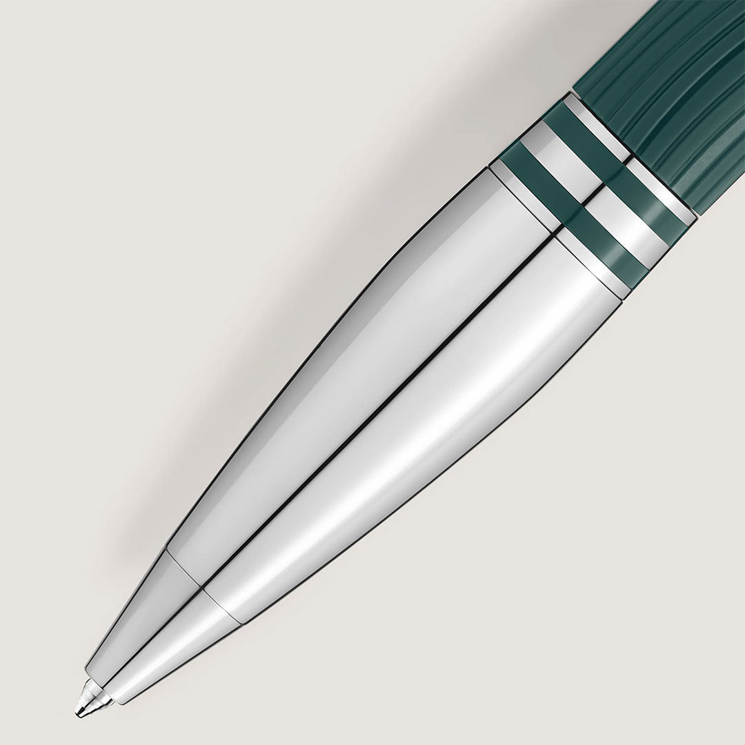Close-up of the Montblanc Starwalker Polar Green Precious Resin Doue Ballpoint Pen, featuring a shiny silver barrel, dark green grip, and two silver bands near the top, by Montblanc, resting on a light neutral background.