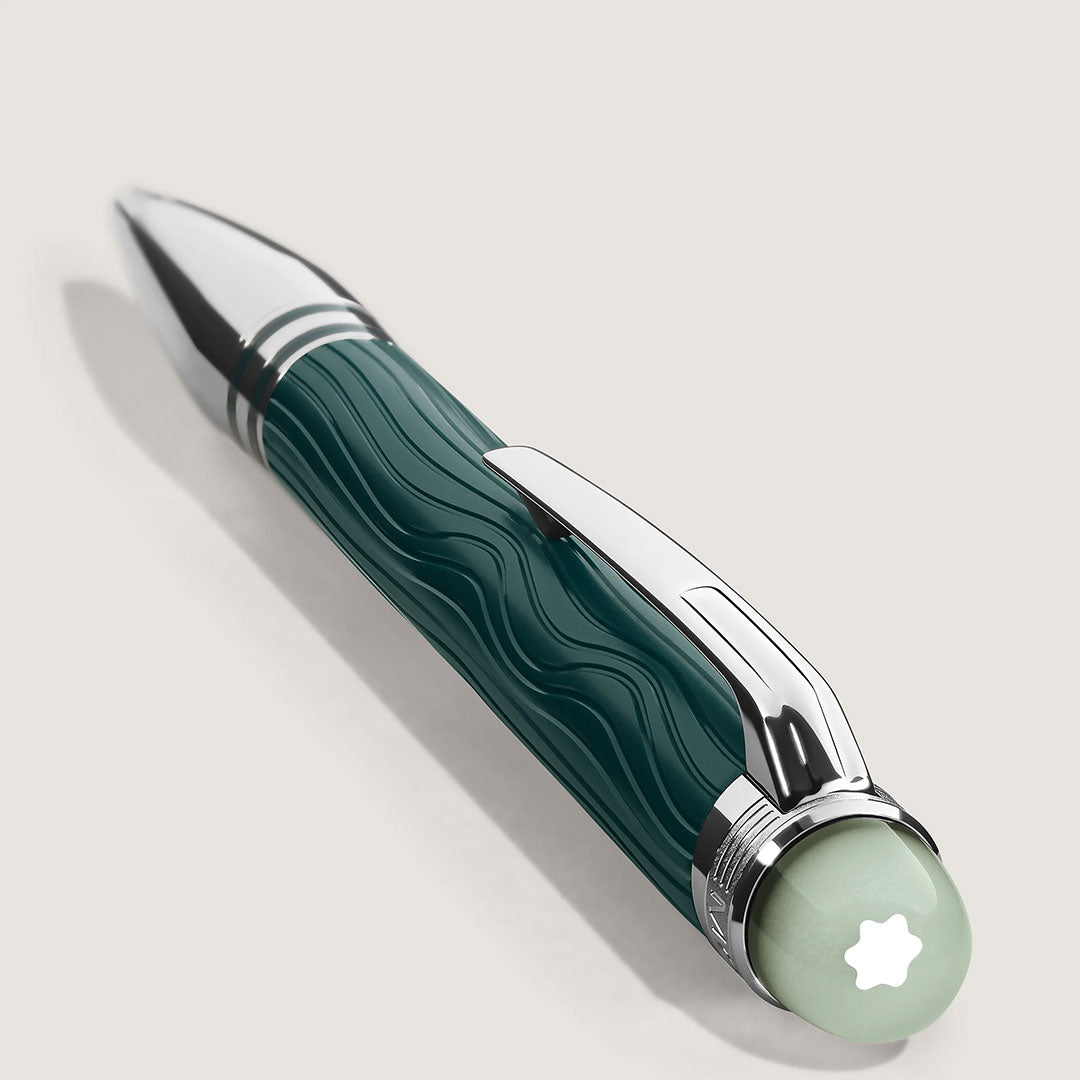 The Montblanc Starwalker Polar Green Precious Resin Doue Ballpoint Pen features wavy green and silver barrel designs, a platinum-coated finish, shiny clip, pale green cap with white star emblem, and is displayed against a light background.