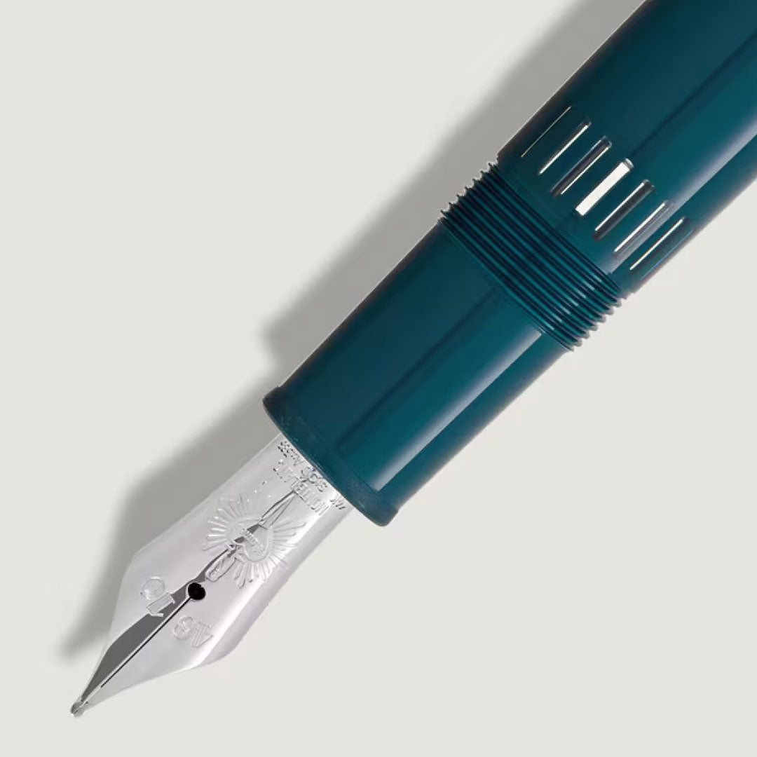 Close-up of the Montblanc Meisterstuck Romeo & Juliet LeGrand Fountain Pen, a teal luxury writing instrument with a silver nib, engraved details, and ridged grip section, set against a plain light background.