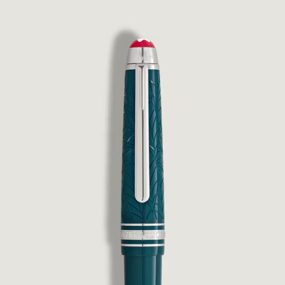 A teal Montblanc Meisterstück Romeo & Juliet LeGrand Rollerball Pen featuring a silver clip, engraved leafy patterns, and a white top with red accent—an elegant creation from Montblanc.