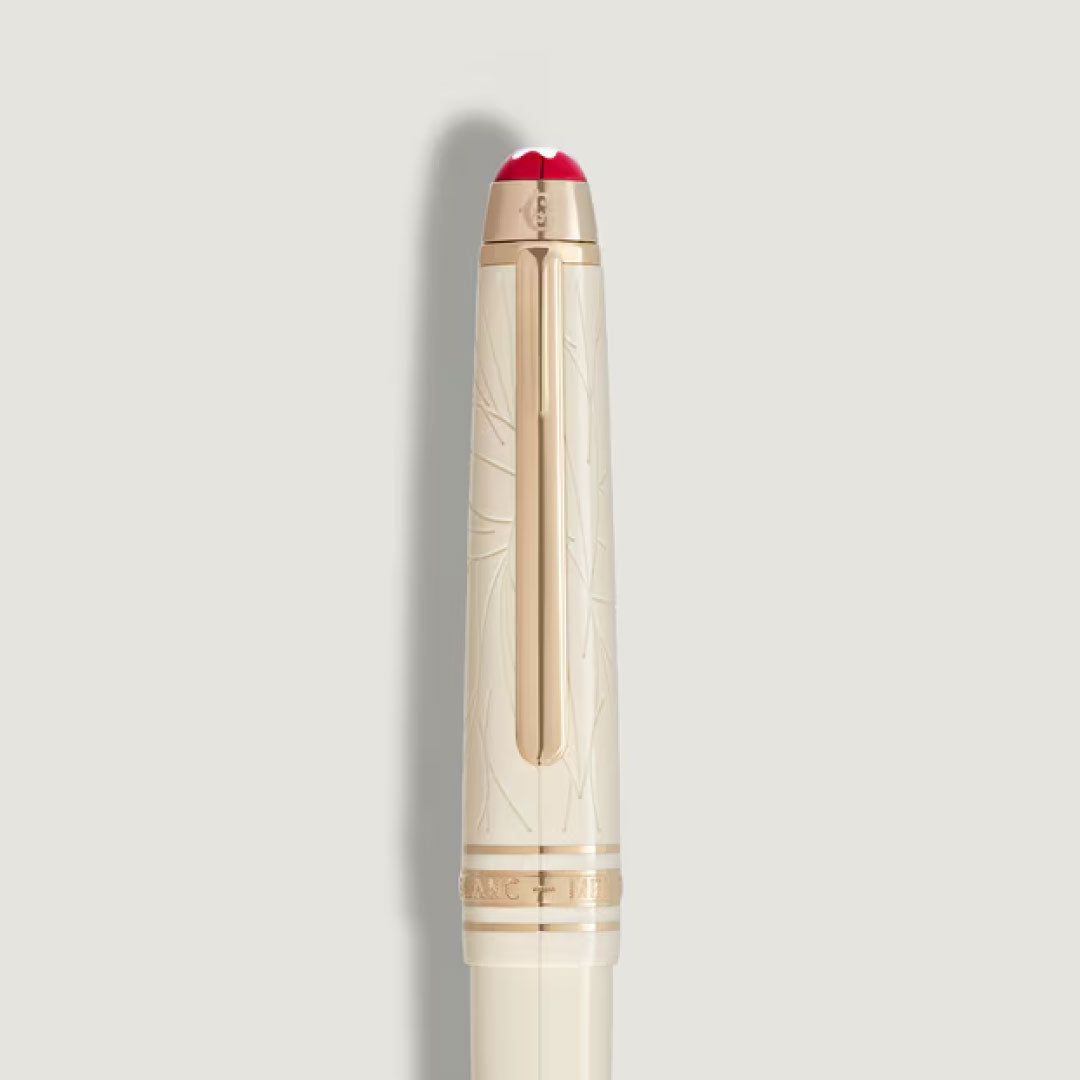 A cream-colored resin cap with subtle engravings, a gold clip, and a red rounded top adds elegance to the Montblanc Meisterstuck Romeo & Juliet Classique Rollerball Pen, set against a light gray background.