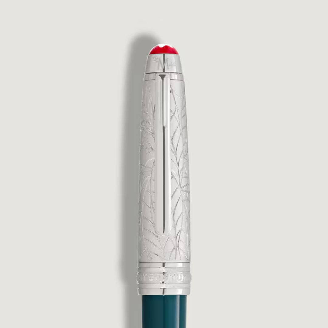 A silver cap engraved with a leaf pattern, featuring red and white accents, tops the dark teal body of the Montblanc Meisterstuck Romeo & Juliet Doue Midsize Classique Ballpoint Pen, crafted from precious resin against a plain light background.