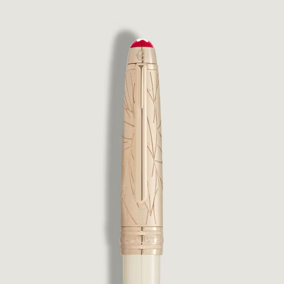 A gold-colored pen cap with an engraved pattern and white-and-red rounded top, set against a plain background—an elegant detail from the Montblanc Meisterstuck Romeo & Juliet Doue Classique Rollerball Pen by Montblanc.