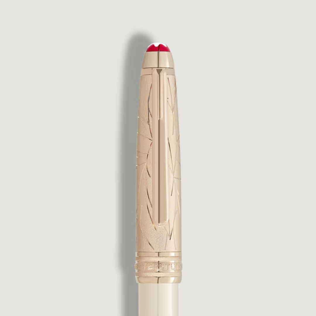 The Montblanc Meisterstück Romeo & Juliet Doue Classique Ballpoint Pen features a gold cap with an engraved feather pattern and a red and white tip, showcased on a plain light background.