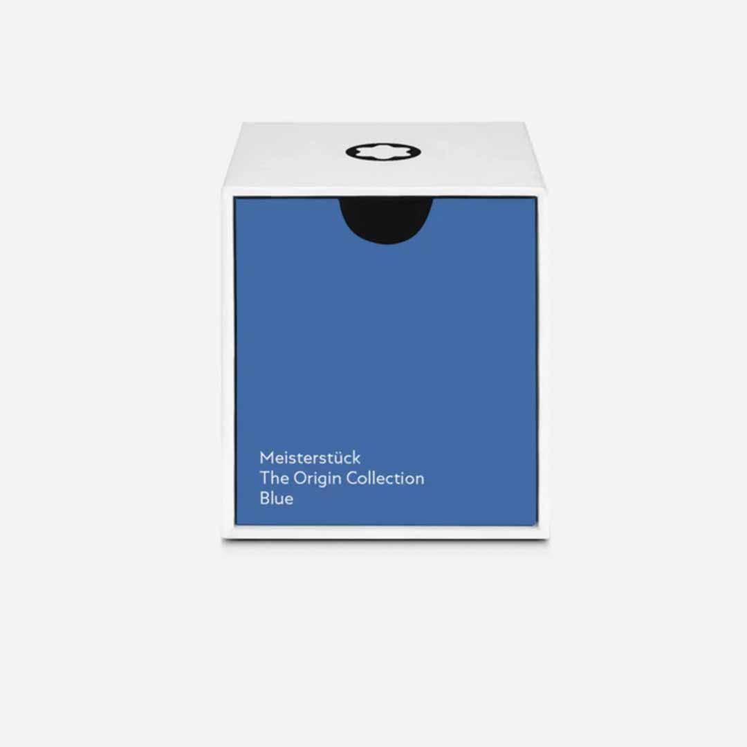 The packaging is a white cube-shaped box with a blue front panel showcasing the text "Montblanc Meisterstuck The Origin Collection Blue - 50ML." Montblanc's iconic black circular logo graces the top, set against a plain, light gray background that enhances the elegance of this Meisterstück creation.