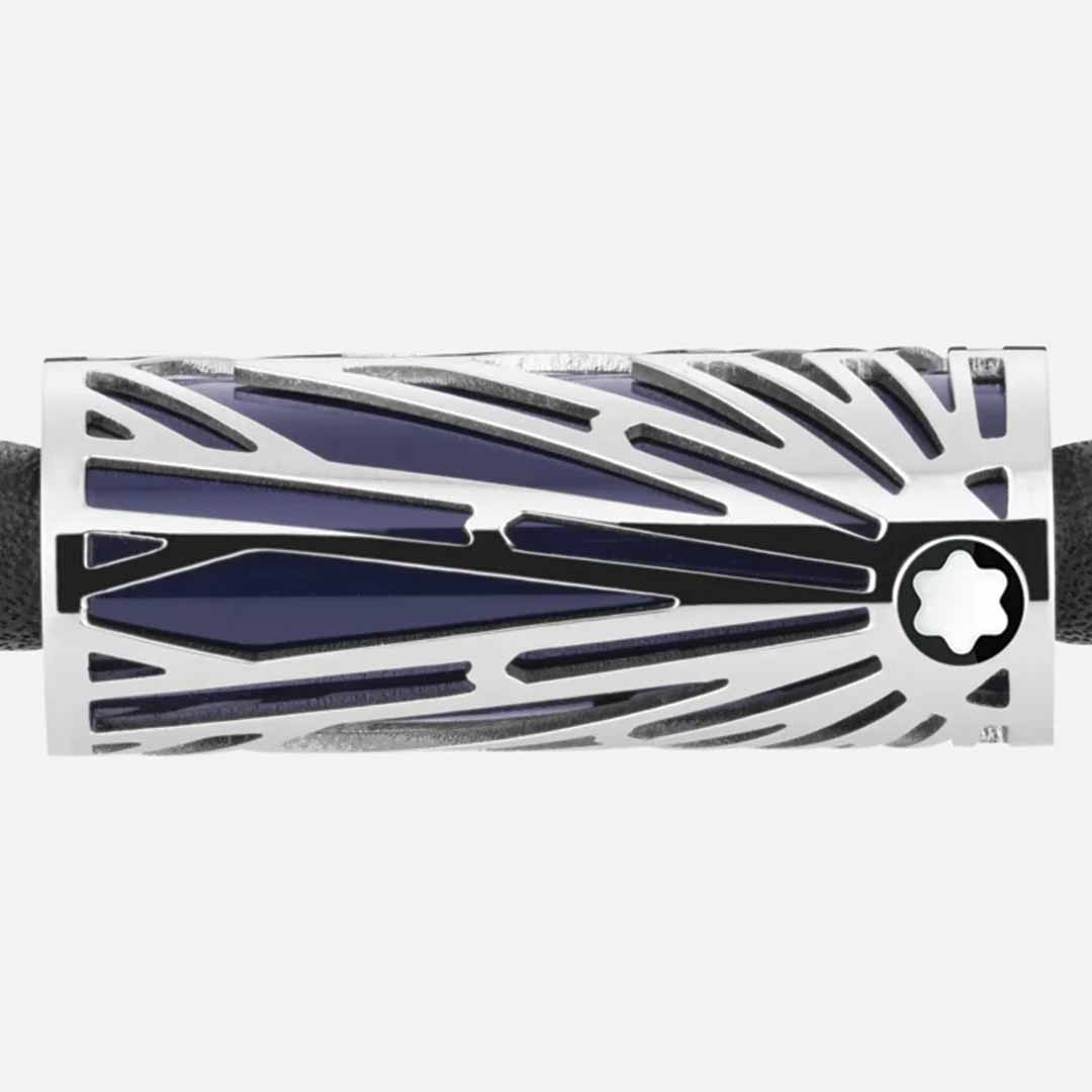 The Montblanc Meisterstuck Origins Blue Leather Bracelet features a sleek, stainless steel rectangular metal accessory with a black and silver geometric design. It is adorned with a star emblem on the right and showcases the intricate Solitaire pattern, which includes diagonal lines and a central blue accent.