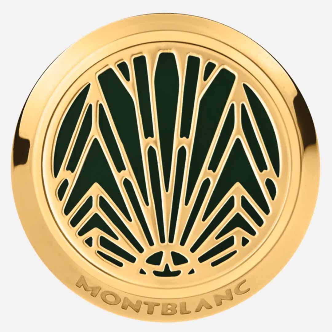 A pair of circular gold cufflinks from the Montblanc Meisterstuck The Origin Collection features intricate, symmetrical cutouts against a dark green background with accents of green lacquer inlay. The design showcases a stylized, abstract geometric pattern, and "Montblanc" is elegantly engraved along the bottom edge, embodying the luxury associated with stainless steel cufflinks.