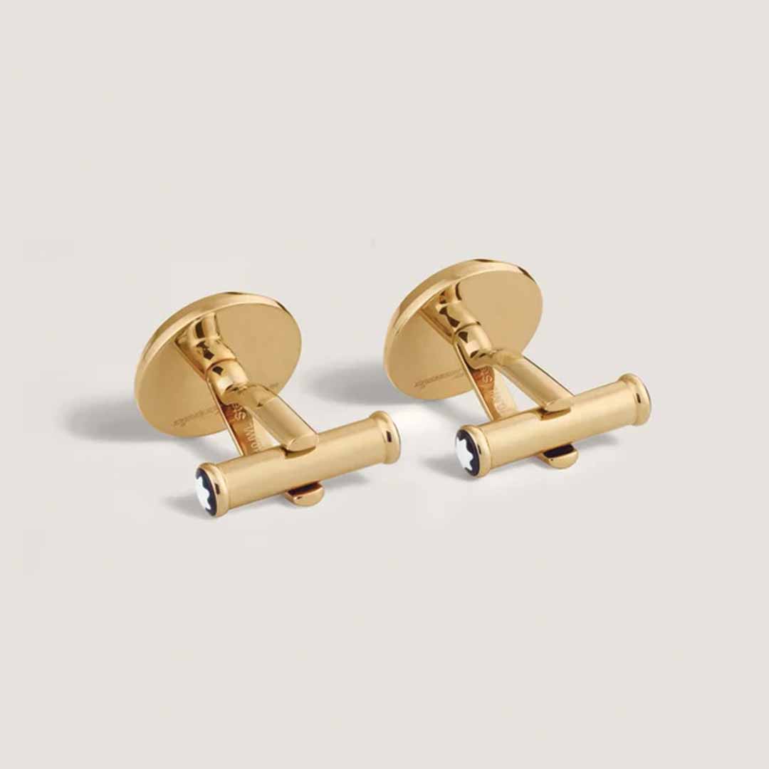 A pair of Montblanc's Meisterstück The Origin Collection Green Cufflinks, featuring a shiny gold color with a cylindrical design and enhanced by lacquer inlay with round backs, are displayed against a simple, light background.