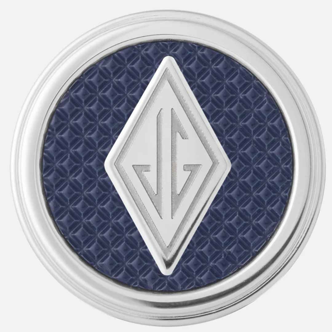 Introducing the Montblanc Great Characters Homage to The Great Gatsby Cufflinks: featuring a round, silver-rimmed design that echoes the elegance of The Great Gatsby era. The cufflinks boast a textured navy blue background with a raised stainless steel diamond shape at the center, embellished with a symmetrical, abstract design.