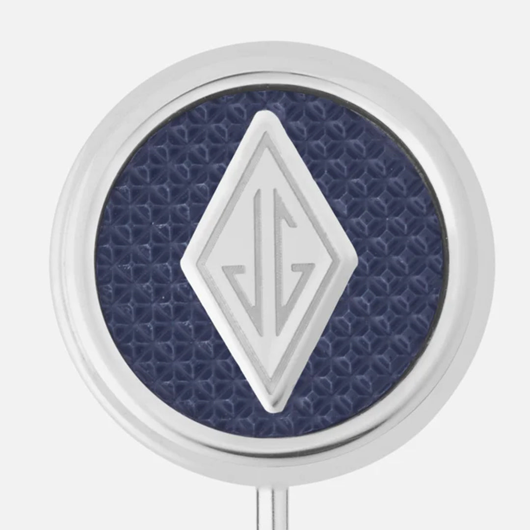The Montblanc Great Characters Homage to The Great Gatsby Stainless Steel Lapel Pin features a textured blue round background with a diamond-shaped metallic design with geometric lines at its center and a smooth silver outer edge.