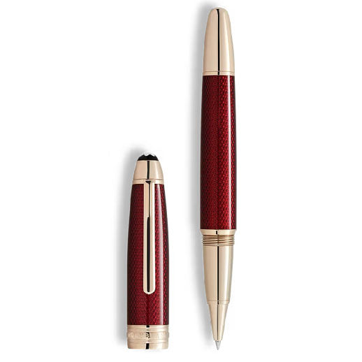 The Montblanc Meisterstück Solitaire Golden Hour Rollerball Pen is shown uncapped with the cap beside it, featuring a textured burgundy red lacquer barrel and elegant gold-coated fittings.