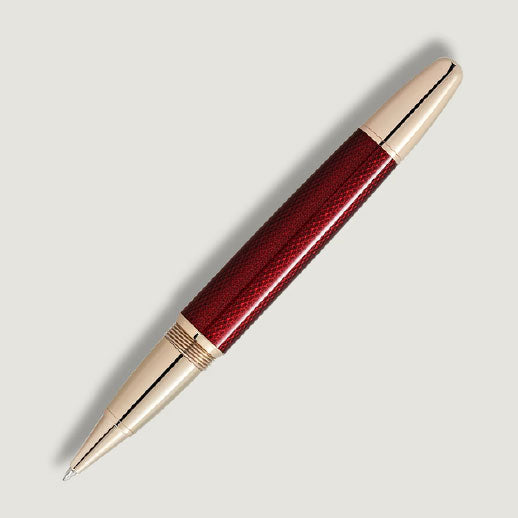 A Montblanc Meisterstück Solitaire Golden Hour Rollerball Pen with a glossy burgundy red lacquer barrel and gold-coated fittings, displayed diagonally on a light gray background.
