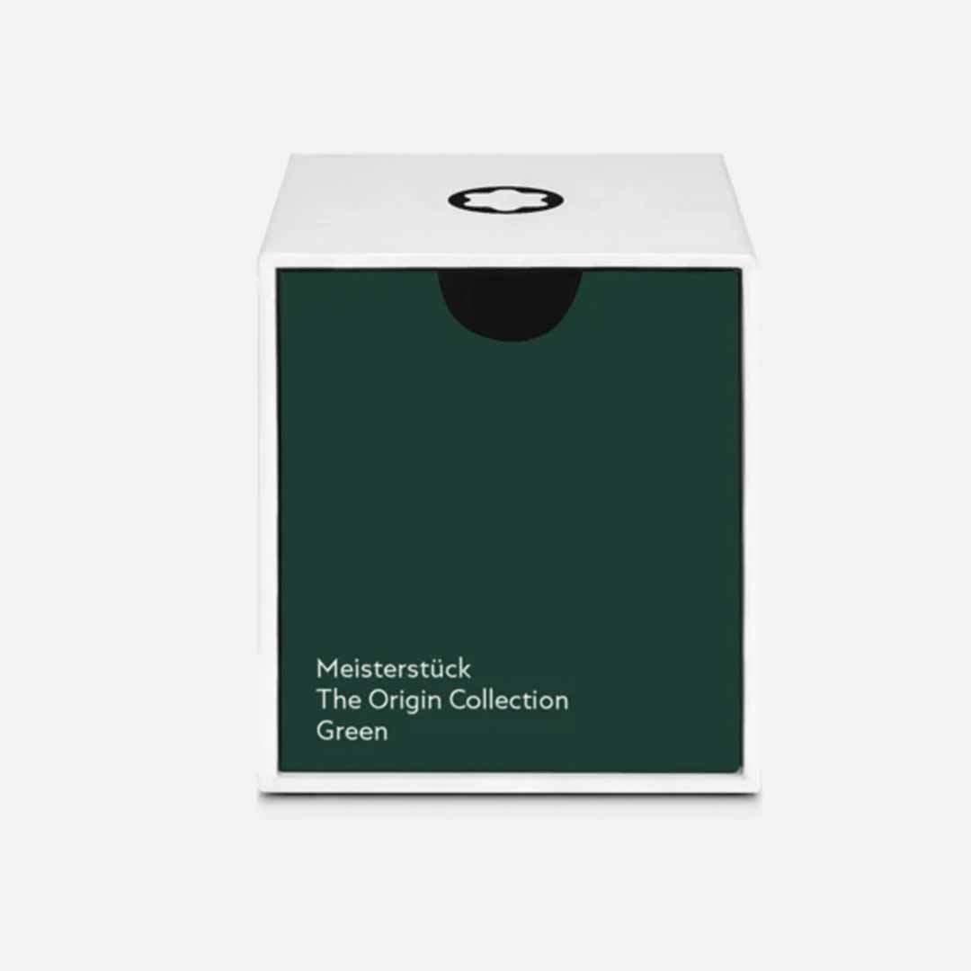 A square box with a white top and dark green front panel displays the text “Montblanc Meisterstück The Origin Collection Green - 50ML.” A black and white circular logo adorns the top. This Montblanc product is set against a plain background, capturing the timeless elegance associated with Meisterstück writing instruments.