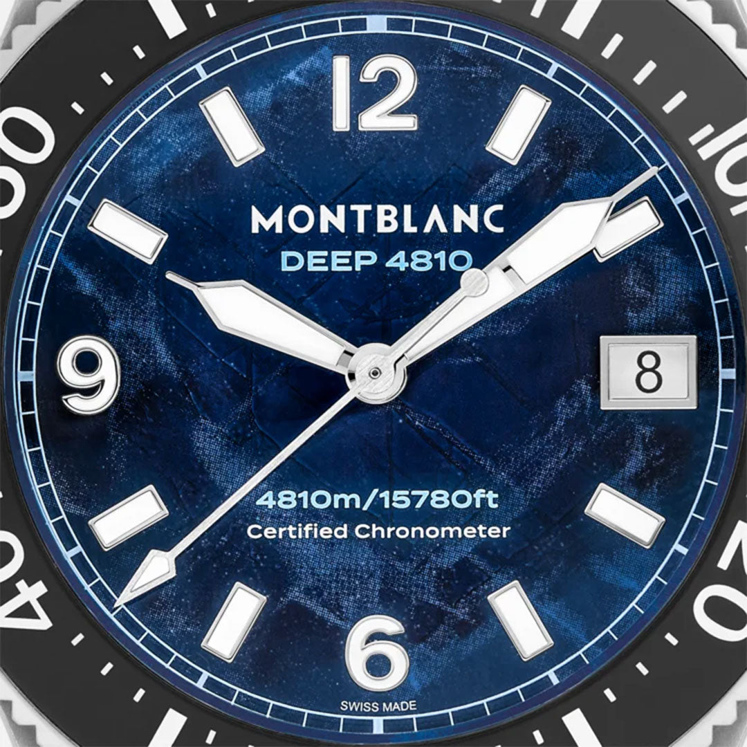 Close-up of a Montblanc Iced Sea 0 Oxygen Automatic 43mm watch face featuring bold white numbers and hands against a deep blue glacier pattern dial. This exquisite diving watch displays the date at the 3 o'clock position and includes text "4810m/15780ft Certified Chronometer.